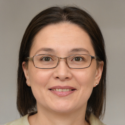 Joyful white adult female with medium  brown hair and brown eyes