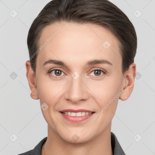 Joyful white young-adult female with short  brown hair and grey eyes