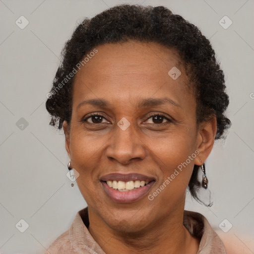 Joyful black adult female with short  brown hair and brown eyes