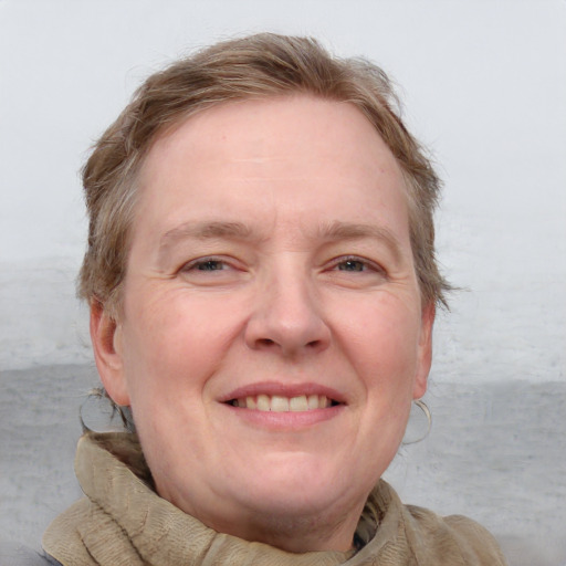 Joyful white adult female with long  brown hair and blue eyes