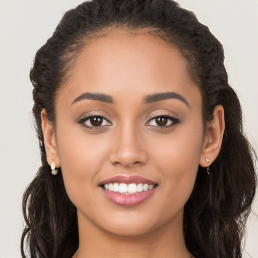 Joyful white young-adult female with long  brown hair and brown eyes