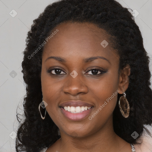 Joyful black young-adult female with long  black hair and brown eyes