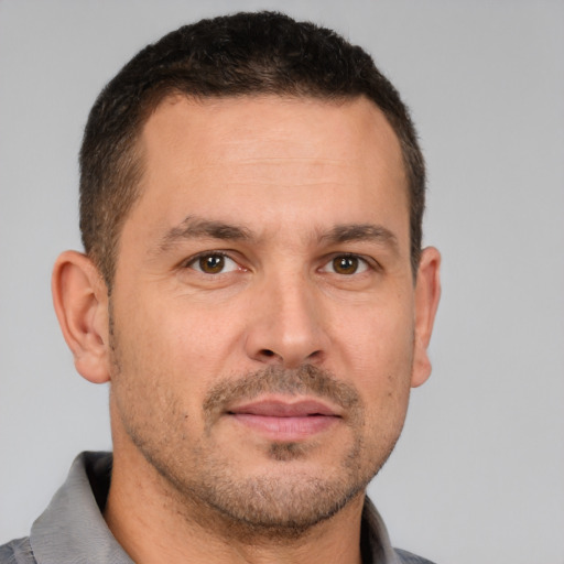 Joyful white adult male with short  brown hair and brown eyes