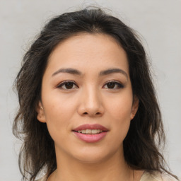 Joyful asian young-adult female with medium  brown hair and brown eyes