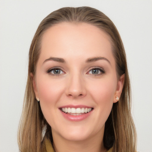 Joyful white young-adult female with long  brown hair and blue eyes