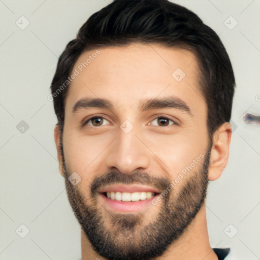 Joyful white young-adult male with short  black hair and brown eyes