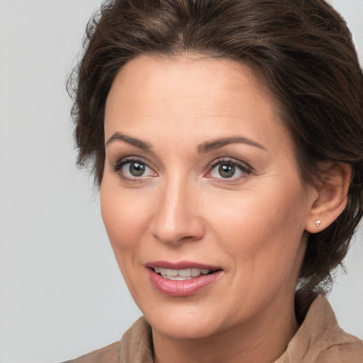 Joyful white adult female with medium  brown hair and brown eyes