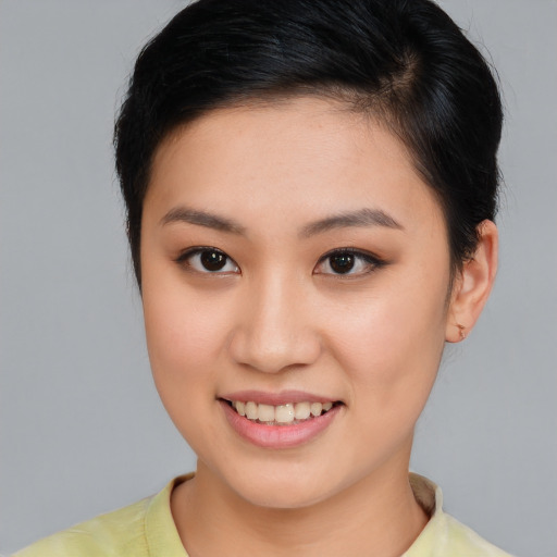 Joyful asian young-adult female with short  brown hair and brown eyes