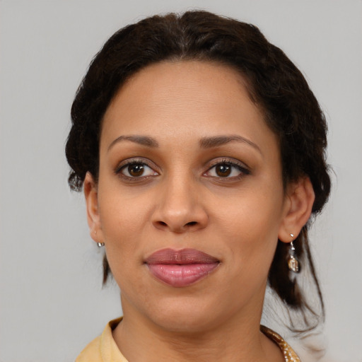Joyful latino adult female with medium  brown hair and brown eyes