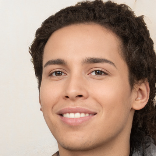 Joyful white young-adult male with medium  brown hair and brown eyes