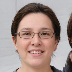 Joyful white young-adult female with medium  brown hair and brown eyes