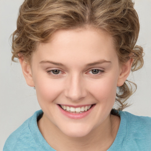 Joyful white child female with medium  brown hair and brown eyes