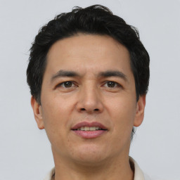 Joyful asian adult male with short  brown hair and brown eyes