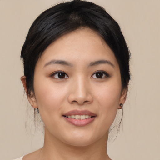 Joyful asian young-adult female with medium  brown hair and brown eyes