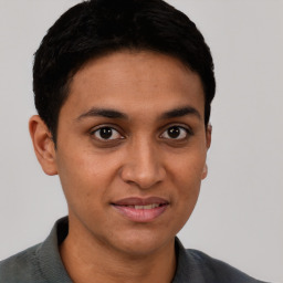 Joyful latino young-adult male with short  brown hair and brown eyes