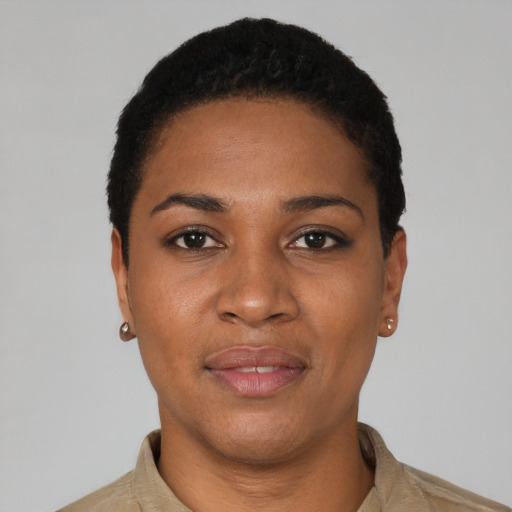 Joyful black young-adult female with short  black hair and brown eyes