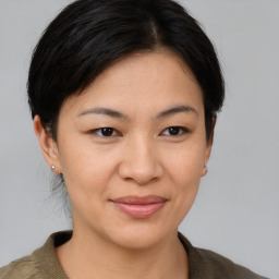 Joyful asian young-adult female with medium  brown hair and brown eyes