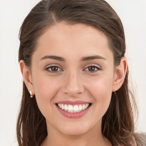 Joyful white young-adult female with long  brown hair and grey eyes