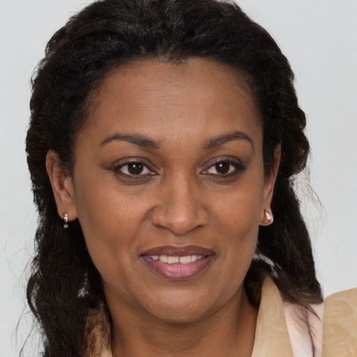 Joyful black adult female with medium  brown hair and brown eyes