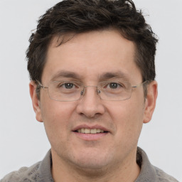 Joyful white adult male with short  brown hair and grey eyes