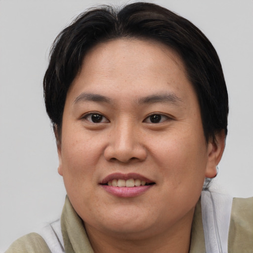 Joyful asian adult female with short  brown hair and brown eyes