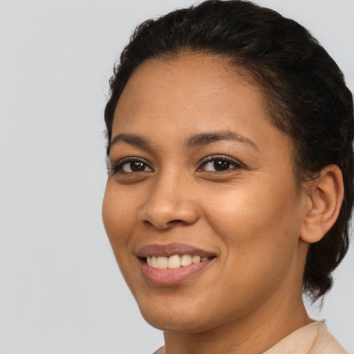 Joyful latino young-adult female with short  brown hair and brown eyes