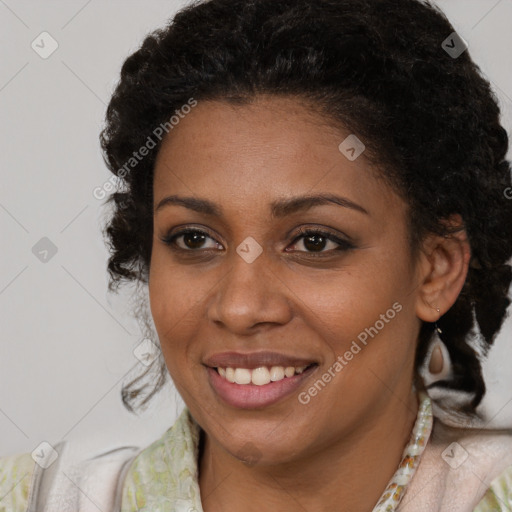 Joyful black young-adult female with medium  brown hair and brown eyes