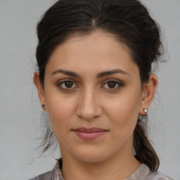 Joyful white young-adult female with medium  brown hair and brown eyes