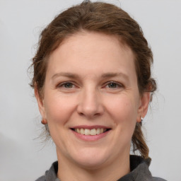 Joyful white adult female with medium  brown hair and grey eyes