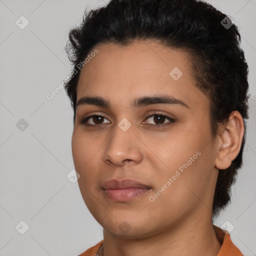 Joyful latino young-adult female with short  black hair and brown eyes