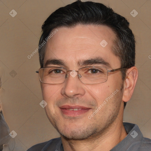 Joyful white adult male with short  black hair and brown eyes