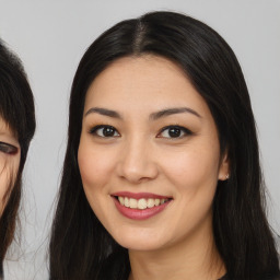 Joyful asian young-adult female with long  brown hair and brown eyes