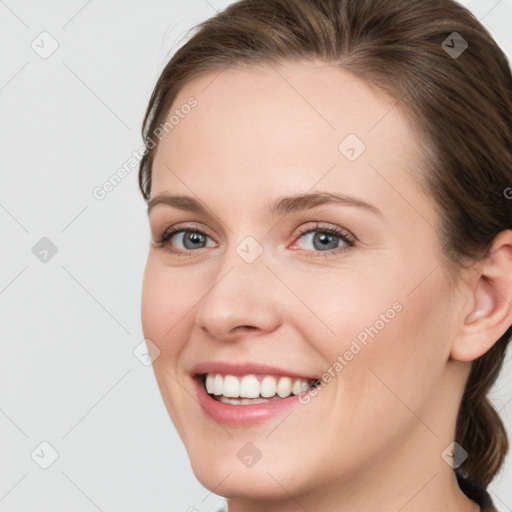 Joyful white young-adult female with long  brown hair and blue eyes