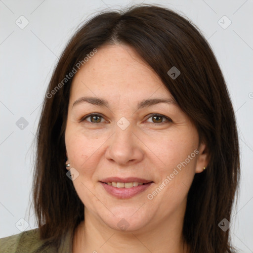 Joyful white adult female with long  brown hair and brown eyes