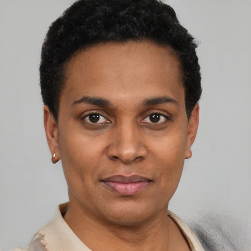 Joyful latino young-adult female with short  black hair and brown eyes