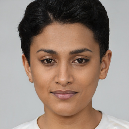 Joyful latino young-adult female with short  black hair and brown eyes