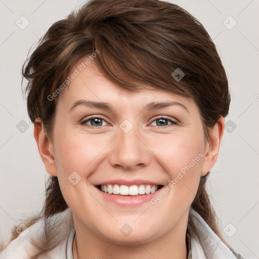 Joyful white young-adult female with medium  brown hair and grey eyes