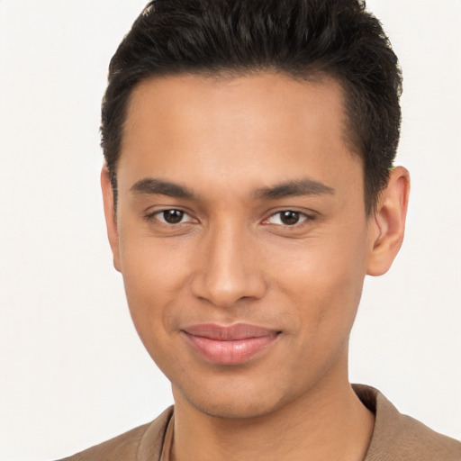 Joyful latino young-adult male with short  brown hair and brown eyes