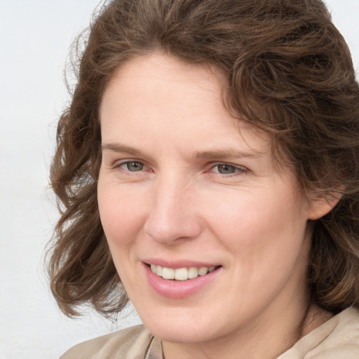 Joyful white young-adult female with medium  brown hair and blue eyes