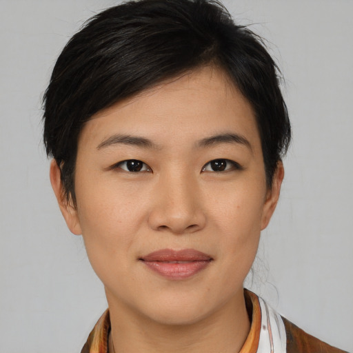 Joyful asian young-adult female with medium  brown hair and brown eyes