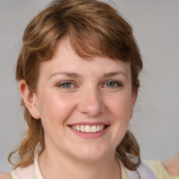 Joyful white young-adult female with medium  brown hair and blue eyes