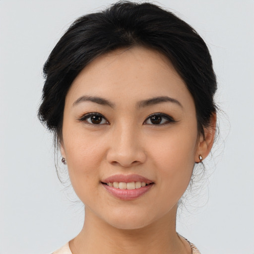 Joyful asian young-adult female with medium  black hair and brown eyes