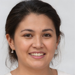 Joyful white young-adult female with medium  brown hair and brown eyes