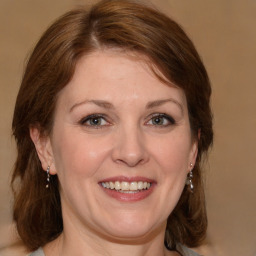 Joyful white adult female with medium  brown hair and grey eyes