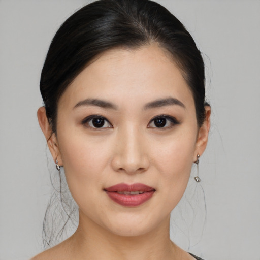 Joyful asian young-adult female with medium  black hair and brown eyes