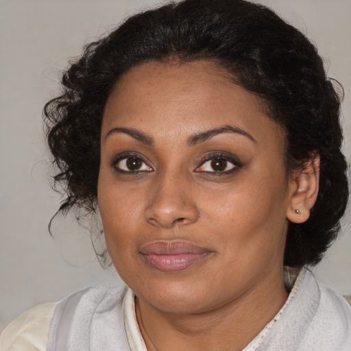 Joyful black young-adult female with medium  brown hair and brown eyes