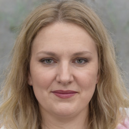 Joyful white adult female with medium  brown hair and grey eyes