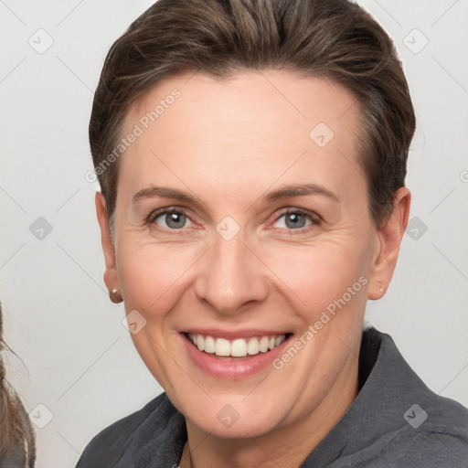 Joyful white adult female with short  brown hair and grey eyes