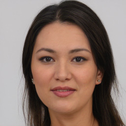 Joyful latino young-adult female with long  brown hair and brown eyes