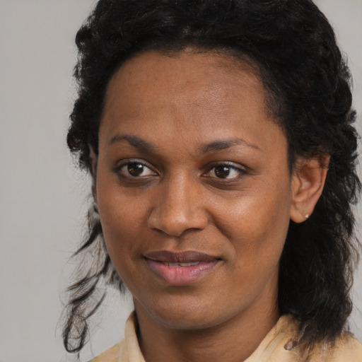 Joyful black young-adult female with medium  black hair and brown eyes
